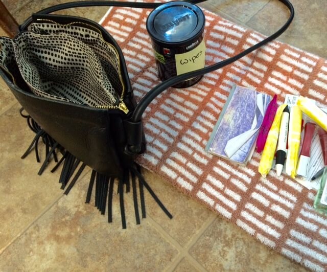 I like to set up at little purse-cleaning station on the floor. I put a clean towel down, and then spread the contents of my purse out on it to wipe down.